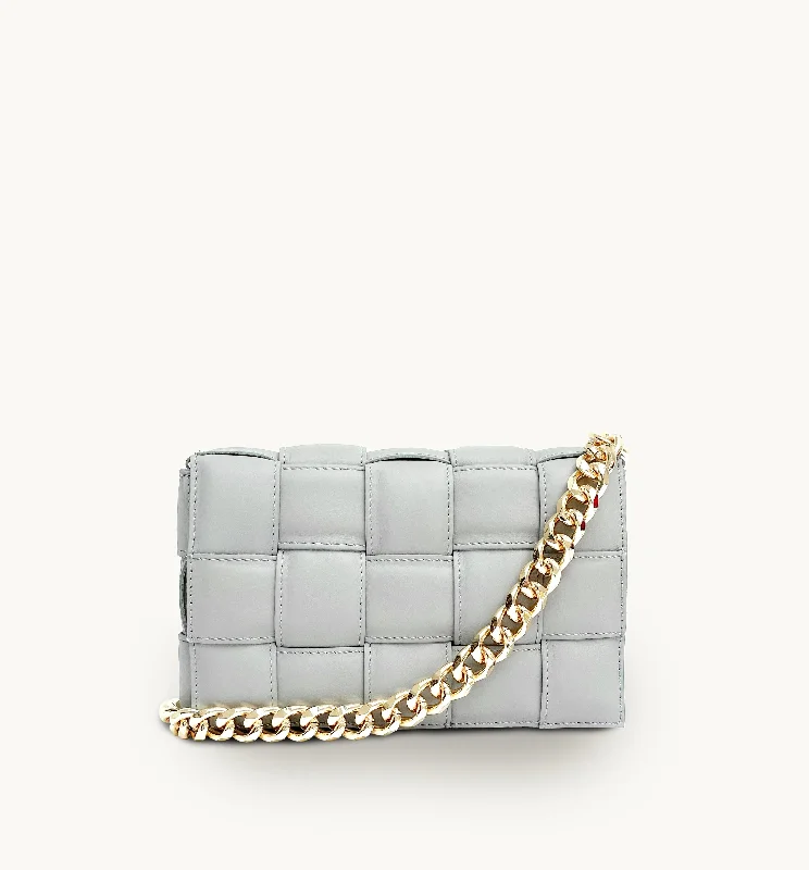 Sleek vinyl crossbody bags with futuristic glossy shine -Clay Padded Woven Leather Crossbody Bag With Gold Chain Strap