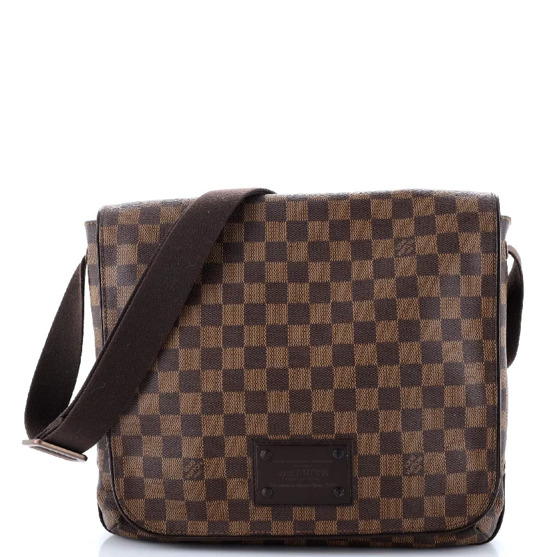 Curved saddle crossbody bags with equestrian-inspired flair -District Messenger Bag Damier MM