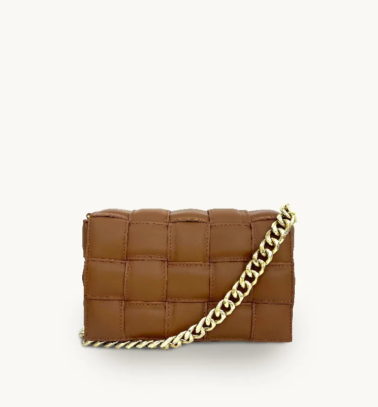 Curved saddle crossbody bags with equestrian-inspired flair -Tan Padded Woven Leather Crossbody Bag With Gold Chain Strap