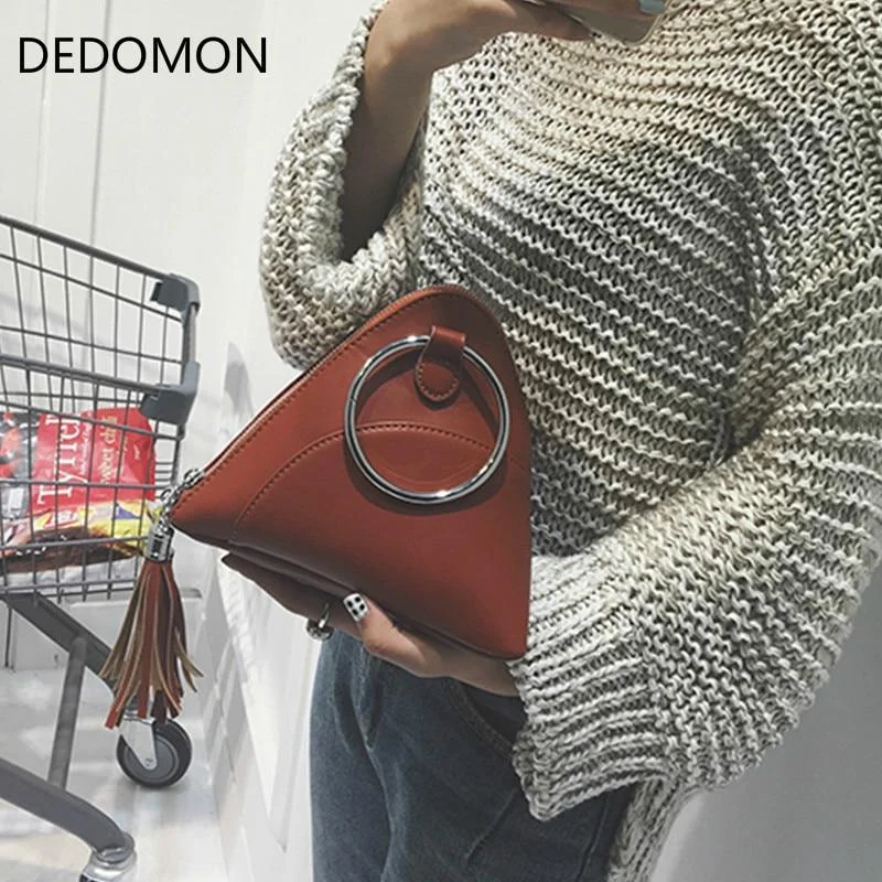 Sleek and simple evening clutches in solid colors for easy matching with outfits -Bag 2018 dumplings package women's handbag mini tassel bag triangle women messenger bags PU